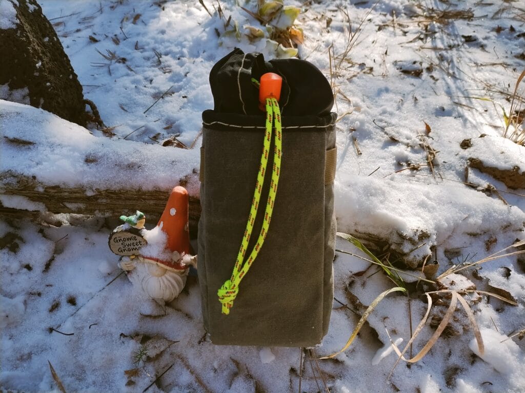 Back view of a DIY bike stem bag in a garden next to a gnome.