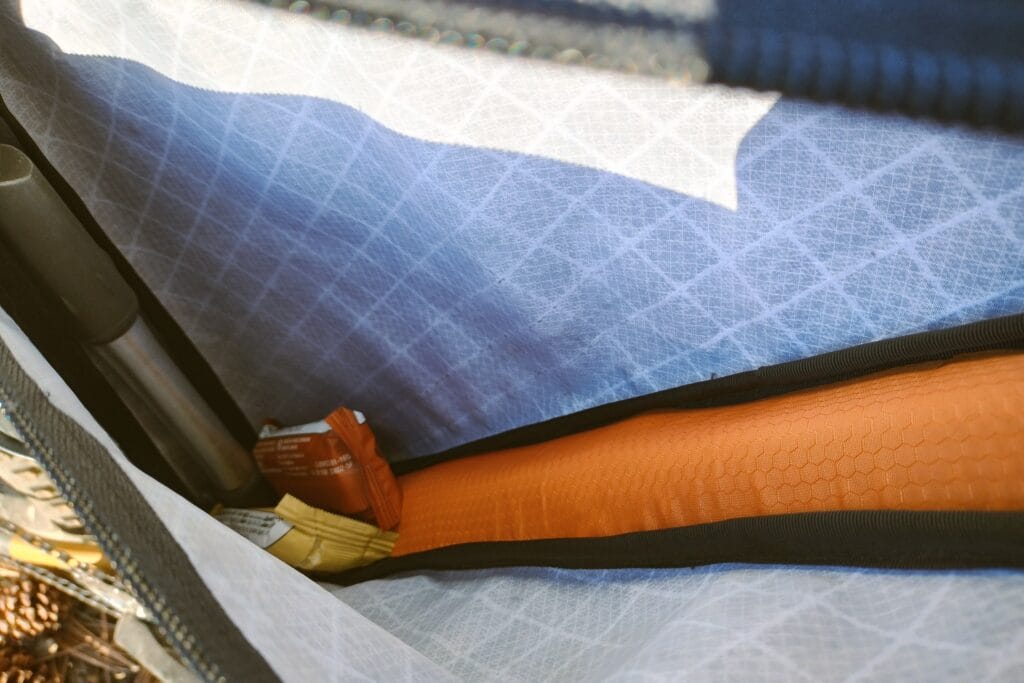 A bike pump and snack bars inside a DIY wedge frame bag.