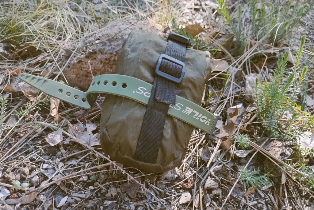 DIY roll top saddle bag with Voile strap in a natural garden.