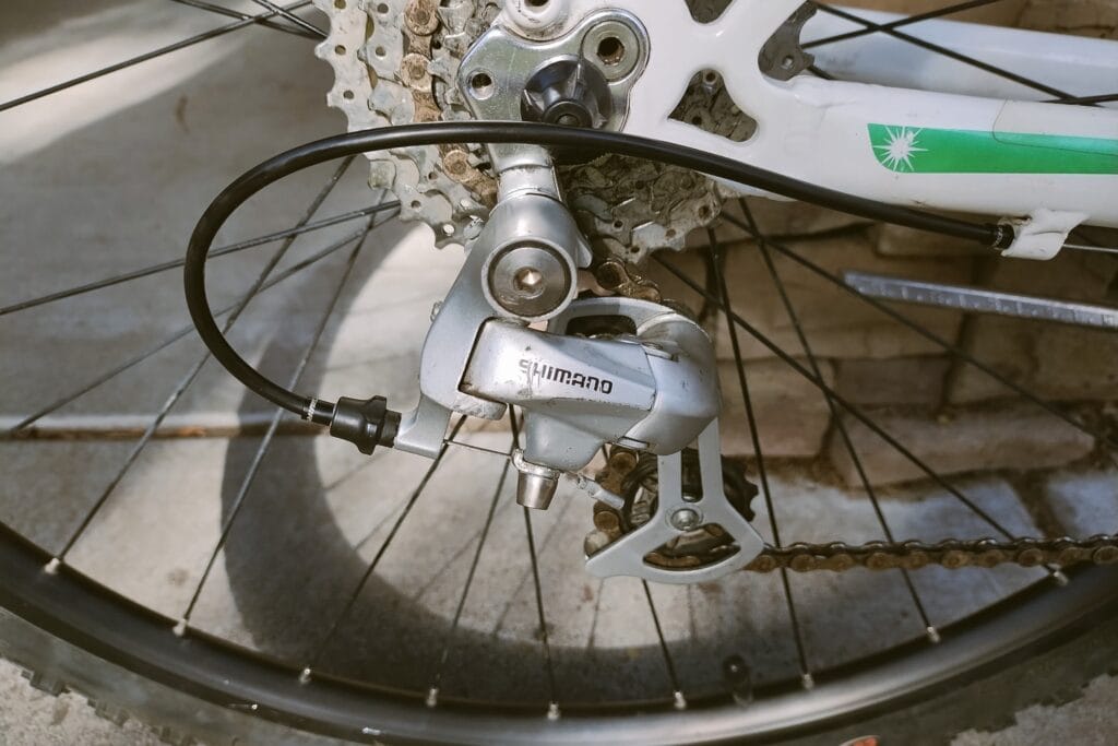 A silver Shimano rear derailleur paired with a SRAM shifter.