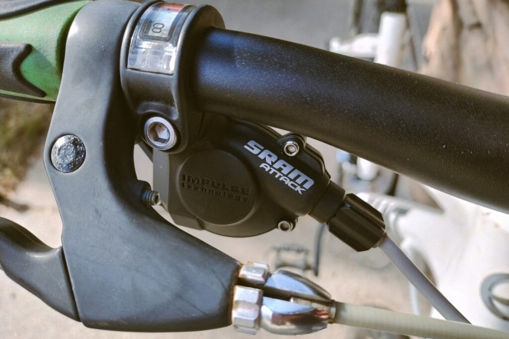 A SRAM Attack rear shifter paired with a Shimano rear derailleur.