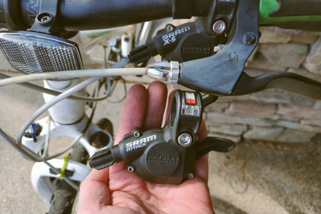 A SRAM Attack shifter next to a SRAM X-5 shifter.