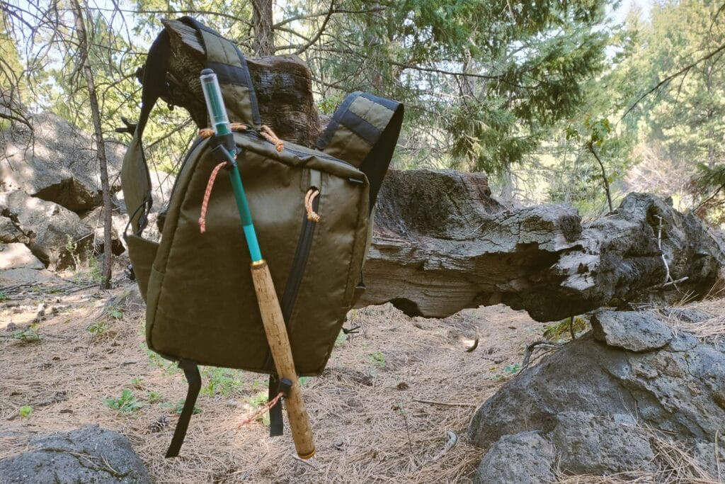 A DIY trail running pack with a tenkara rod attached.